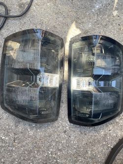 TL-ZTL-002-BK-SM 14-18 CHEVY SILVERADO/SIERRA BLACK SMOKE AS IS SCRATCH LENS TAILIGHTS.