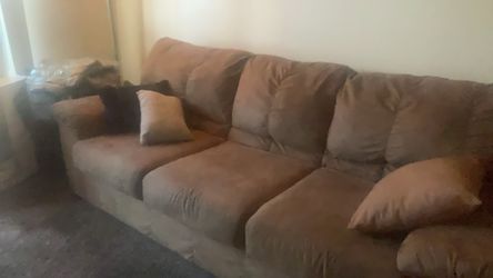 Tan swayed couch
