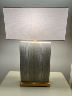 NEW 2-Lamps in snakeskin with gold trim. 27 1/2 “high and lamp shade is 18” by 8”. New and in perfect condition.