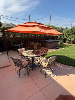 Iron Accent mosaic metal patio set with 4 swivels chairs and umbrella