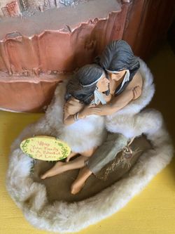 Native American couple wrapped in an animal skin