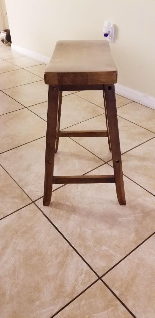 Brown dining table with built in wine rack and chairs
