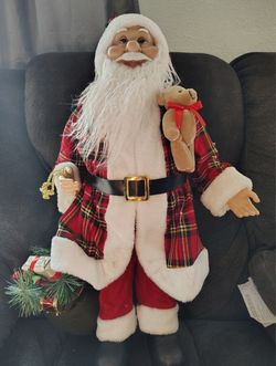 Santa Claus in a plaid coat with a teddy bear is part of the collection