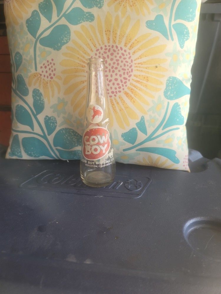 This is a vintage Cowboy Bottling Co. soda bottle from Stockton, California.