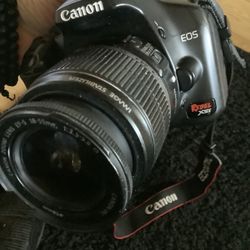 Canon Rebel XSi DSLR camera with EF-18-55mm f/3.5-5.6 II telephoto lens, battery, and 16GB SD card