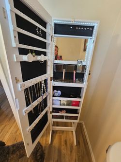 standing mirror jewelry cabinet armoire with a full-length mirror and LED lights