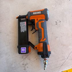 Excellent RIDGID R138HPF3 pneumatic pin nailer. This orange and grey tool is a 23 gauge nailer with a fastener length range of 1/2 inch to 1-3/8 inch.