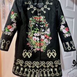 cashmere coat with elaborate embroidery.