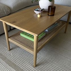 Wood coffee table with rattan shelf
