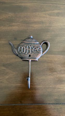 decorative cast-iron wall hook shaped like a coffee pot
