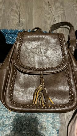 brown KKXIU synthetic leather backpack purse featuring a braided design and a tassel.