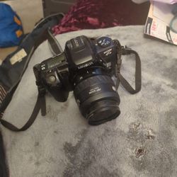 Minolta This 35mm Film Camera And Telephoto Lense