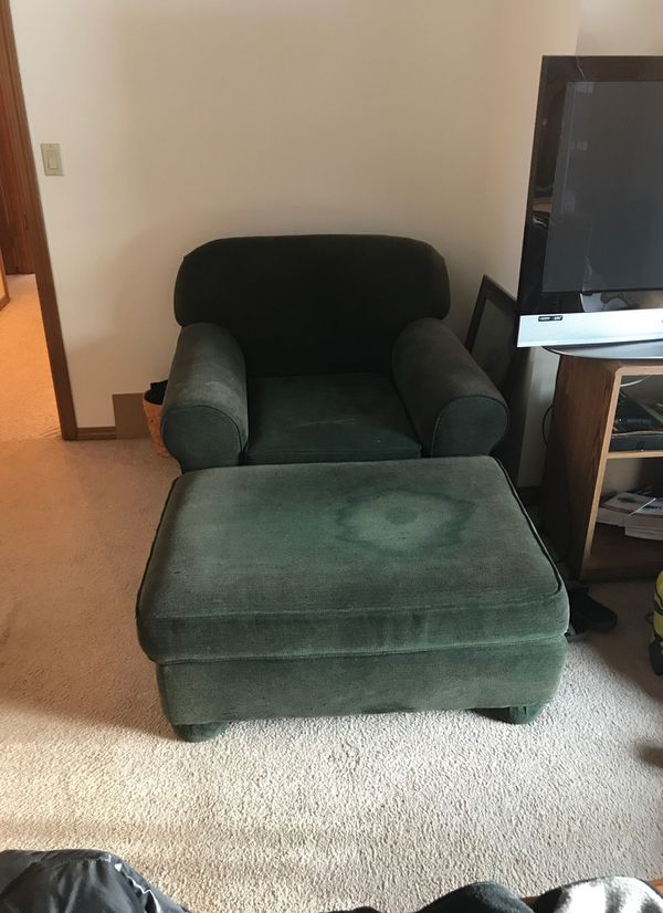Overstuffed chair with ottoman. Ottoman has stain and