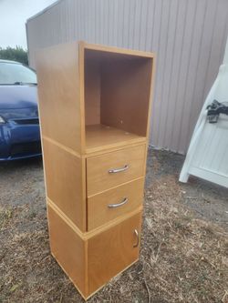 This appears to be a wooden storage cabinet with an open shelf, two drawers, and a bottom cabinet.