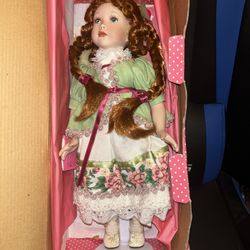 New in box. Porcelain doll.