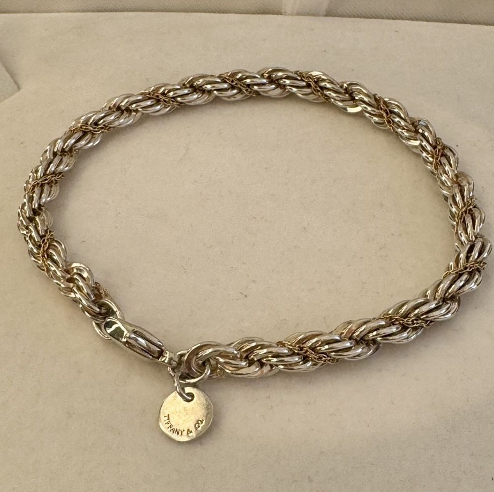 This is an authentic Tiffany & Co bracelet made of sterling silver with a 925 metal purity. The bracelet features a rope design and is styled as a cuf