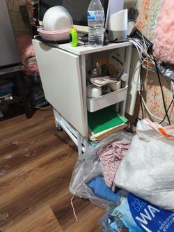 Table that folds down on each side with 2 baskets underneath for storage on wheels