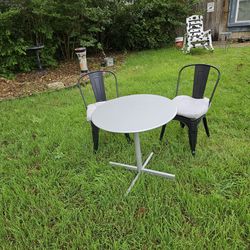 Bistro patio or balcony set.  Two Black Steel Stackable Chairs and silver metal Foldable table