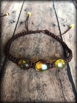 ** Men’s brown macrame bracelet with amber stones.