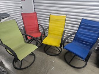 Wrought iron table, four rocking chairs and a bonus