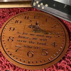 This is a wooden wall clock featuring the Bible verse "As for me and my house, we will serve the Lord" from Joshua 24:15. 