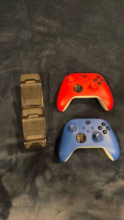 Blue and red xbox controllers and charging doc