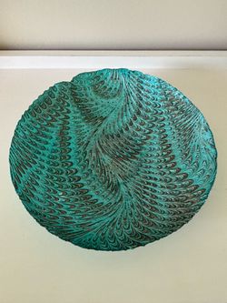 This is a Turkish Akcam decorative glass plate featuring a swirling teal and black peacock pattern.