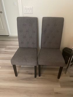 Two grey upholstered chairs