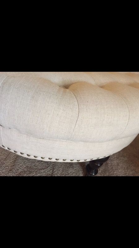 White round tufted ottoman.