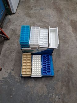 Plastic ice trays, 14 total and container to but ice in