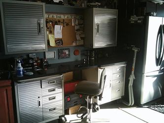 Garage cabnets with granite top, fridge too.