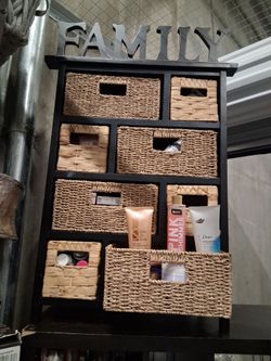 Tetbury 8 Drawer Storage Unit in black. It features a solid wood and MDF frame paired with eight removable woven
