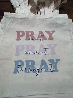 Pray on it tote bag