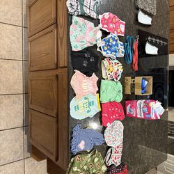 15 small dogie outfits, 2 leashes , large bag of disposable diapers, pet waste baggies