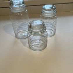 Three Glass Jars With Glass Tops 