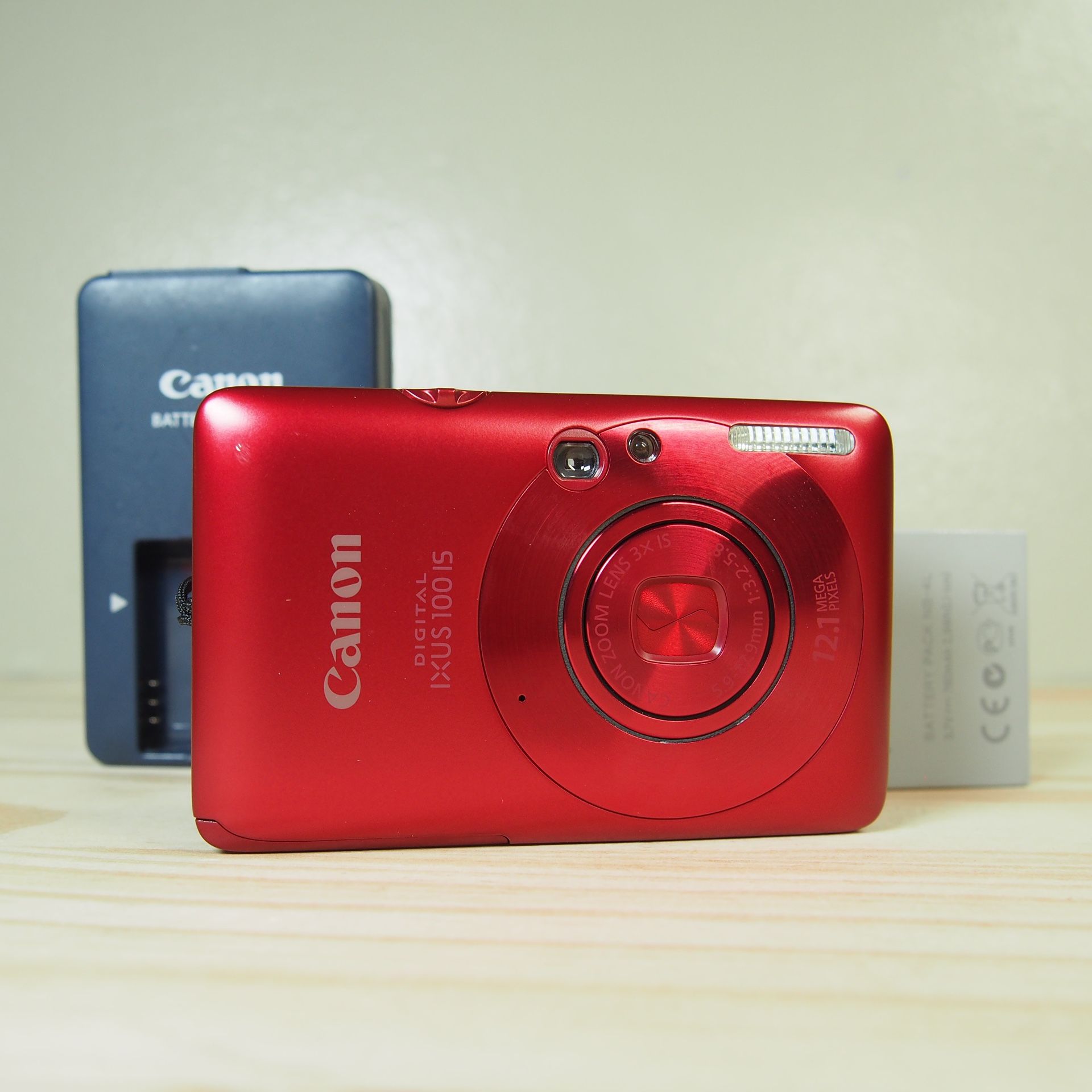 Canon PowerShot IXUS 100 IS 12.1MP Digital Camera Bundle Red w/charger + Battery Comes with: Camera Charger Battery Wrist Strap *ask for a memory card