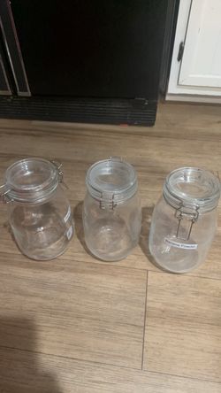 Set of 3 wire bail glass jars with clamp lids.