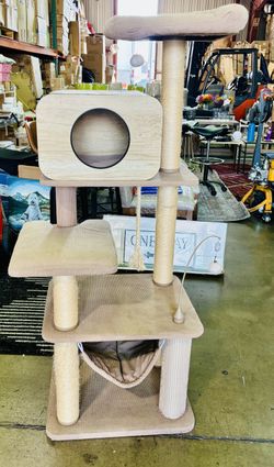 multi-level cat tree featuring a wooden condo, a hammock, scratching posts, and hangingtoys.