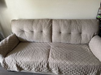 Beige tufted loveseat couch