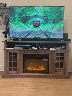 Wooden entertainment center with electric fireplace