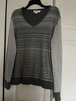 It’s Very Good Sweater Made By Calvin Klein. The Size Is Medium. The Color Is Gray It’s For Man’s 