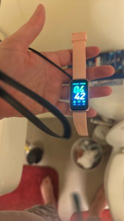 Fit bit and a charger and a smart watch and a charger