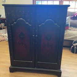 Beautiful cabinet with dark espresso and deep red and gold artistic painting.