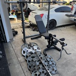 Bench press/squat rack with 320lbs of Olympic weights plus 7ft 45lbs bar and 5ft bar