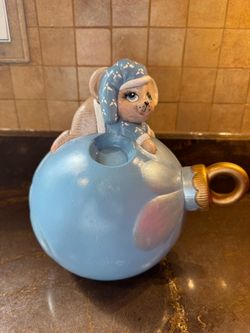 vintage ceramic blue Christmas mouse figure perched on a large blue ornament ball