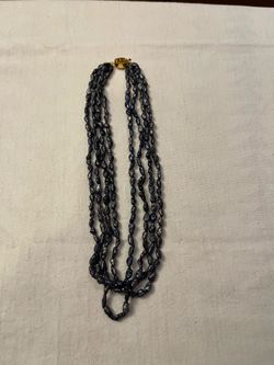 This stunning vintage multi-strand necklace features iridescent black peacock freshwater pearls in a unique, organic "rice" or semi-baroque shape. The