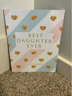 Cute sketchbook with a pink and light blue striped cover. It has gold glitter hearts and says 'BEST DAUGHTER EVER' on the front. Great for drawing or 