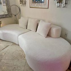 Modern curved modular sofa in a soft cream