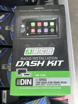 The Metra WM-TYK01 is a car radio installation dash kit designed to fit both single and double DIN aftermarket radios in select Toyota, Ford, Mazda, S