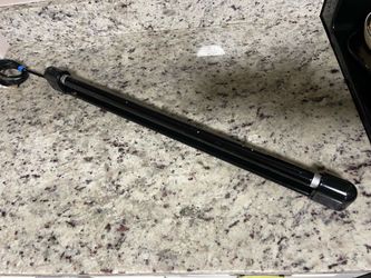 Sleek black light bar with coiled power cable. 24”